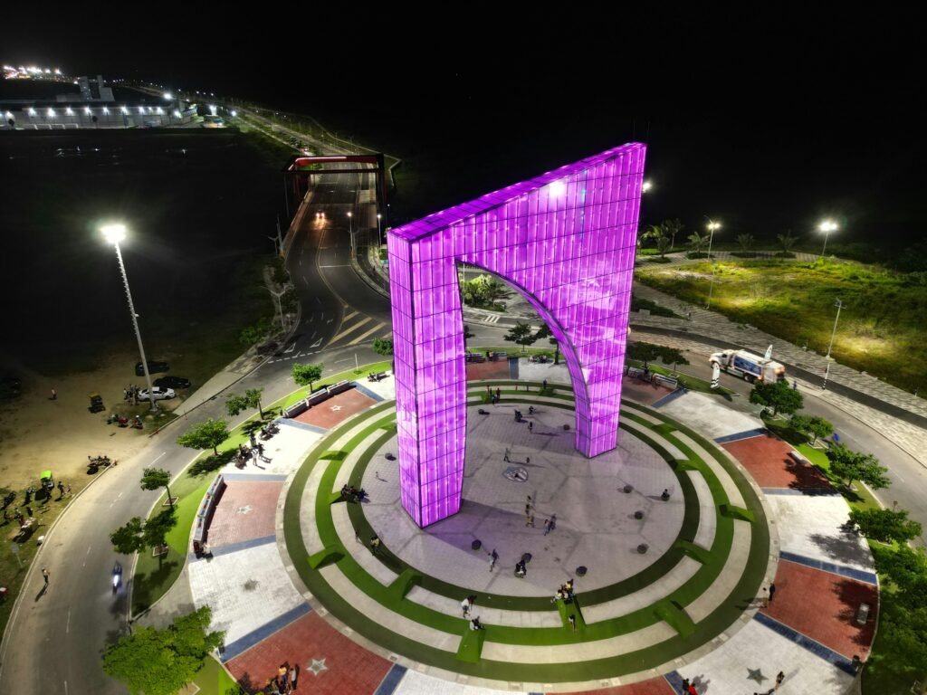 A stunning aerial view of a brightly lit monument in Barranquilla, Colombia, at night.